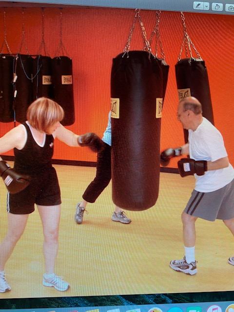 Adults boxing at Rochester School of Fitness with Everlast heavy bags