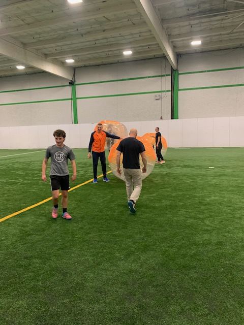 Bumper soccer game — teams competing inside inflatable bubble suits