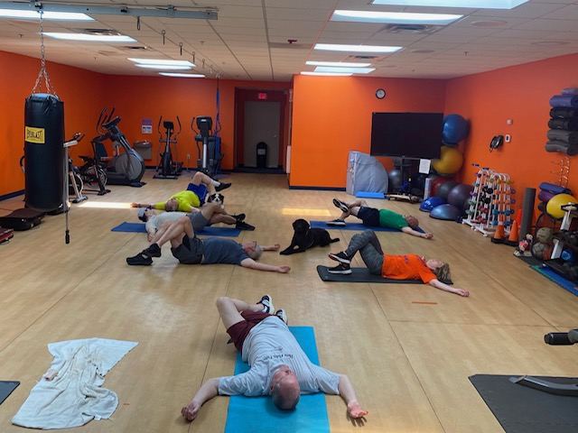 RSF group class members doing cool-down stretching together